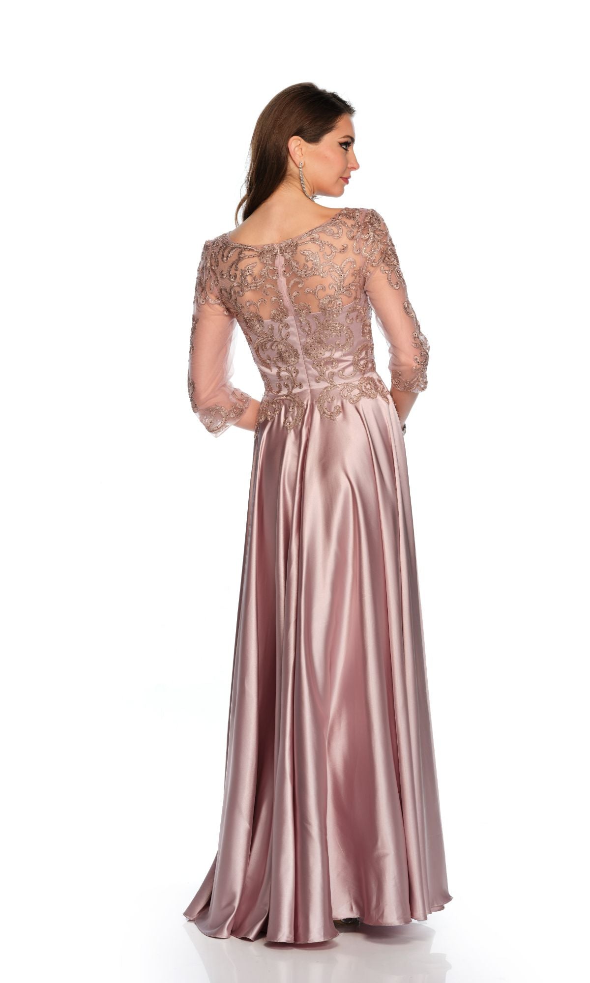 Woman wearing the Long Formal Dress 11362 by Dave and Johnny, a mauve pink gown featuring lace embroidery on the bodice and sheer sleeves, standing with her back to the camera against a white background.